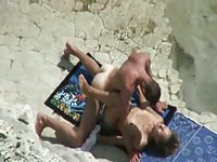 Tan amateur lovers strip naked and enjoy hardcore fucking session on public beach