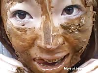 Asian girl making her poop a face mask