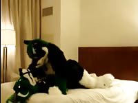 Costumed couple fucking on the bed