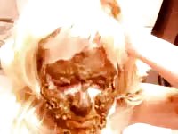 Masked blonde spreads her shit on her face