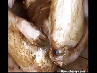 Dirty woman masturbates while covered in shit