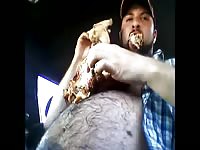 Hairy man recording himself while eating chicken